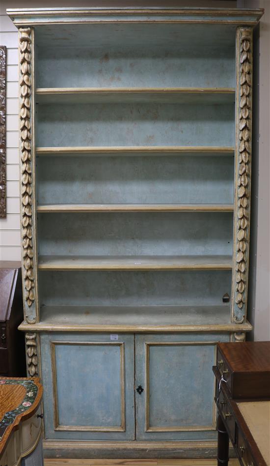 A tall Italian painted and decorated bookcase cupboard W.126cm